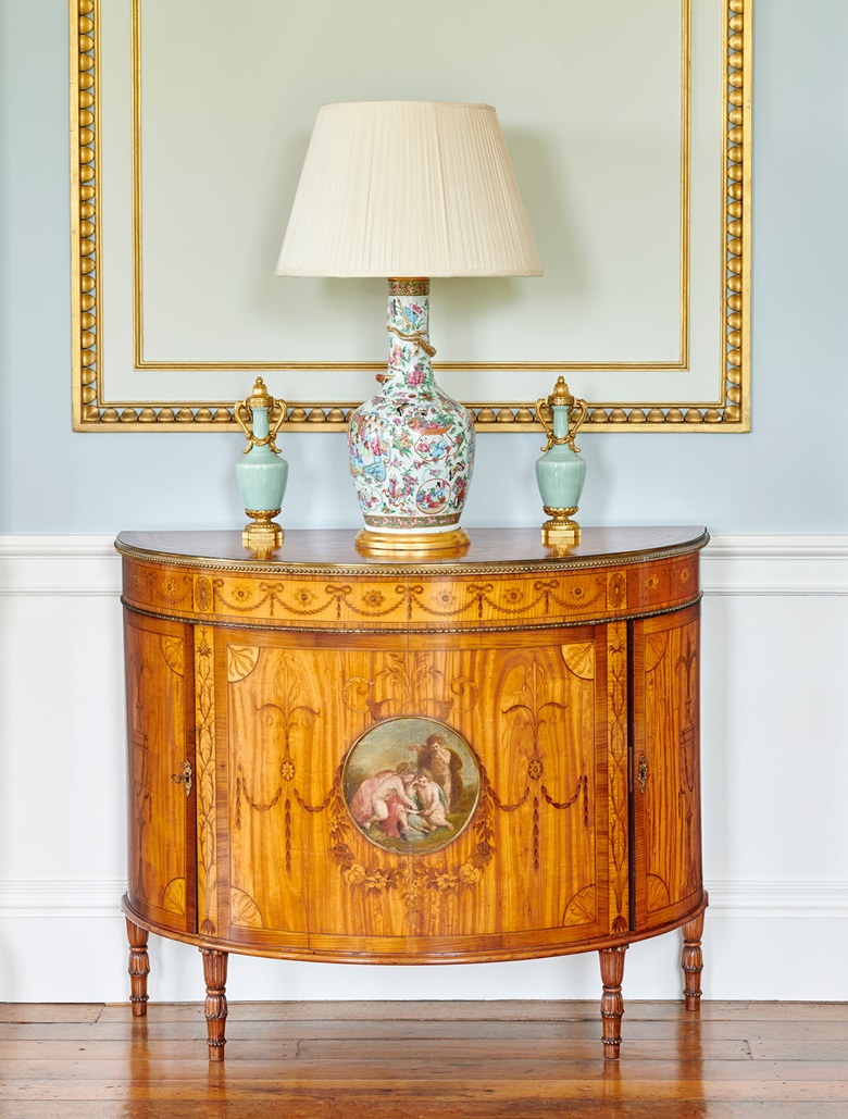 One of a pair of George III gilt-metal mounted east Indian satinwood, Indian rosewood, sycamore, harewood, marquetry and painted demi-lune commodes. Attributed to William Ince and John Mayhew, circa 1775-80. 34½ in (87.5 cm) high; 42½ in (108 cm) wide; 19⅜ in (49 cm) deep. Sold for £151,200 on 22 November 2022 at Christie’s in London from the Collection of Lord and Lady