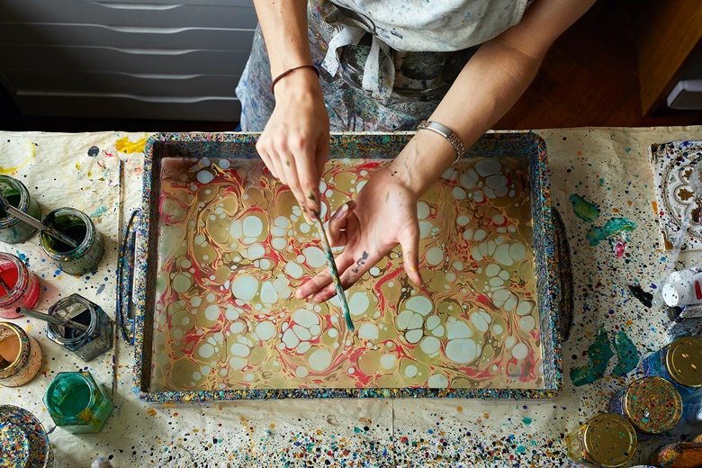 The hands of paper marbler Lucy McGrath, who founded her studio, Marmor Paperie, in 2015. Photo James Winspear. Courtesy of Lucy McGrath