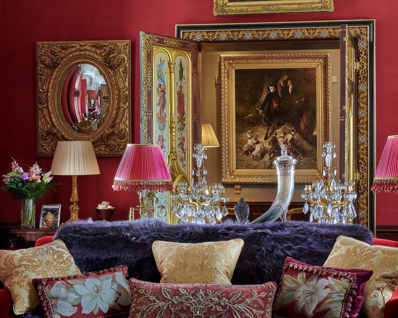 To the left of the Venetian doors in the Drawing Room is one of a pair of north Italian giltwood convex mirrors, circa 1780 (estimate £20,000-30,000). The silver-plated horn cup and cover, centre, is early 20th century (estimate £800-1,200) and the cushions come from a group of 20, reusing 17th- to 20th-century ecclesastical textiles (estimate £2,000-3,000). All offered in An