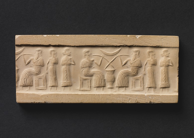 An impression from a cylinder seal depicting two figures drinking beer through straws at a banquet. Mesopotamia, Iraq, 3rd millennium BC. Chert IAA 1965-84. Photo The Israel Museum, Jerusalem, Elie Posner