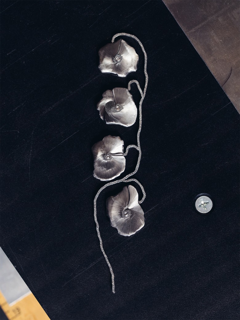 Poppies, 2010. Hand-carved stainless-steel brooch set with diamonds. Photo Geordie Wood