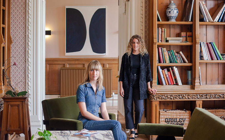 CURA Art founders Georgia Powell (left) and Liza Shapiro in the library at Oakley Court in Berkshire, England. Photo © Jayne West Photography