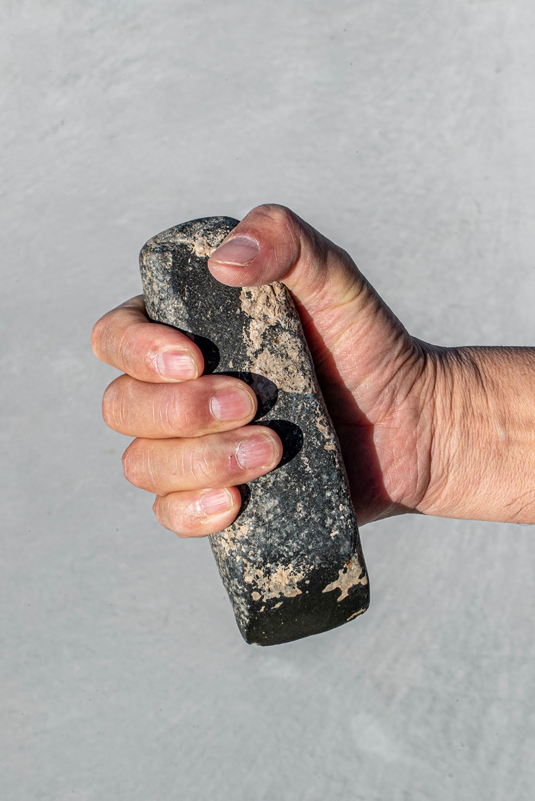 Ai Weiwei holding a stone tool from Still Life, 1993-2000. © Image courtesy Ai Weiwei Studio