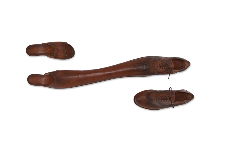 Yoan Capote (b. 1977), Casados, 2004. Height 4 in (10.2 cm) Width 32 in (81.3 cm) Depth 10 in (25.4 cm) dimensions variable when installed. Leather, wood and shoe laces. Sold for $21,420 in Latin America Art Online on 14 March 2023 at Christies online