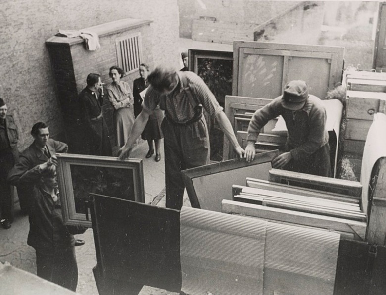 Edith Standen, Rose Valland and a soldier converse while men prepare paintings for transportation, 1946. James J. Rorimer papers, 1921-1982. Archives of American Art, Smithsonian Institution