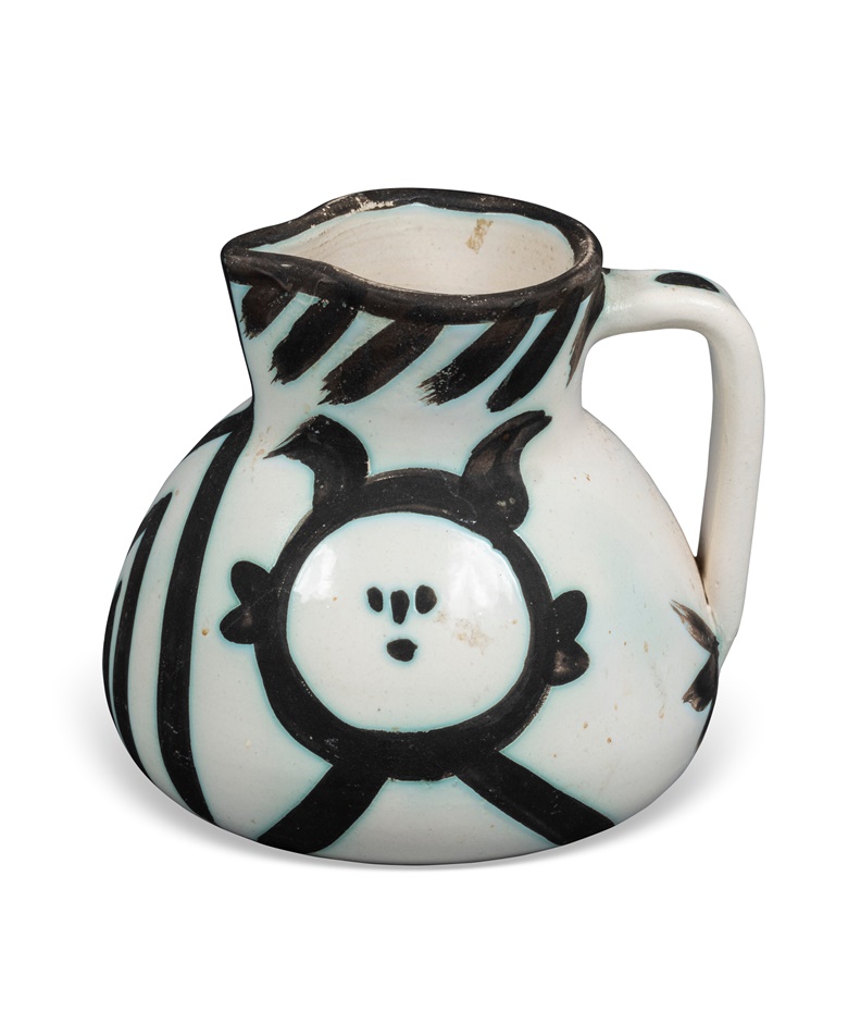 Pablo Picasso (1881-1973), Pichet têtes, Conceived in 1953 and executed in an edition of 500. White earthenware ceramic pitcher with black oxide and white glaze. Height 5½ in (13.9 cm). Estimate $2,000-3,000. Offered in Impressionist & Modern Art Day Sale on 13 May 2023 at Christie’s in New York
