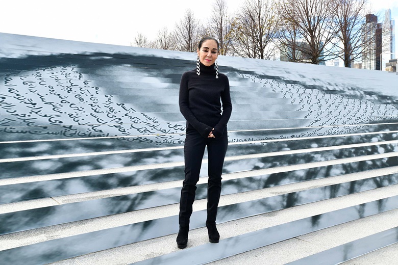 Shirin Neshat with her artwork Eyes on Iran, New York, 2022. Photograph by Eugene Gologursky via Getty Images for WomanLifeFreedom.today