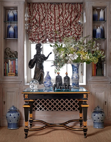 Lynn Chadwick’s Maquette II Sitting Couple on Bench, 1984 (£80,000-120,000) rests on a French ebonised and parcel-gilt centre table, late 19th century (£1,500-2,500). On the shelves are Andrew Wicks’s Garniture of Eleven Blue Ombré Vases, 2014 (£4,000-6,000)
