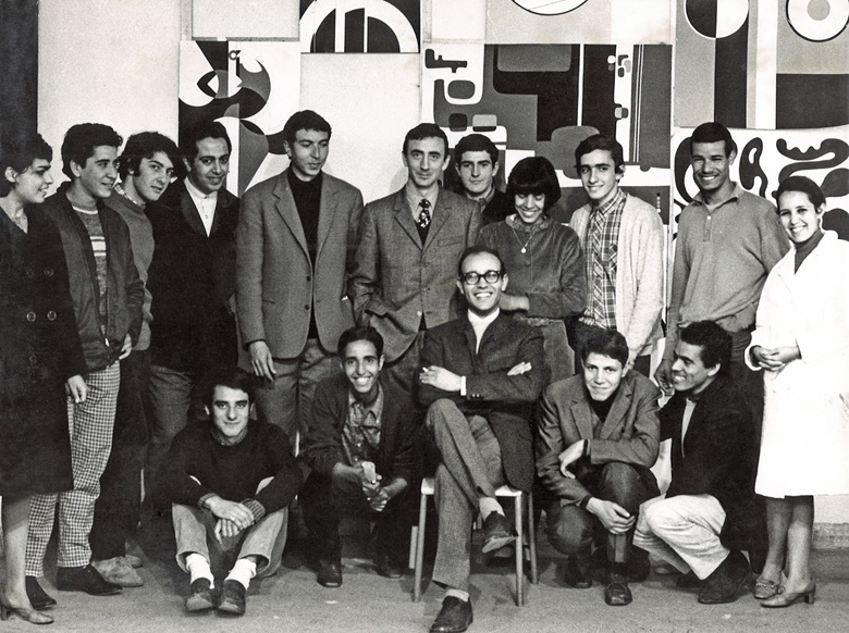 Mohamed Melehi (in chair) at the Casablanca Art School with a group of teachers (including Mohammed Chabâa and Farid Belkahia) and students (among them, on the far right, Malika Agueznay). Photograph by Toni Maraini. Photo Courtesy of Malika Agueznay