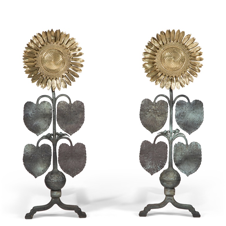 Thomas Jeckyll (1827-1881), pair of rare and important sunflower andirons, c. 1878-1884. Polished brass, patinated wrought-iron, wrought-iron. One andiron 33⅝ in (85.5 cm) high, 19½ in (49.5 cm) wide, 11¼ in (28 cm) deep; the other 34 in (86.4 cm) high, 20 in (50.8 cm) wide, 11¼ in (28.6 cm) deep. Estimate $30,000-50,000. Offered in The Ann & Gordon Getty Collection
