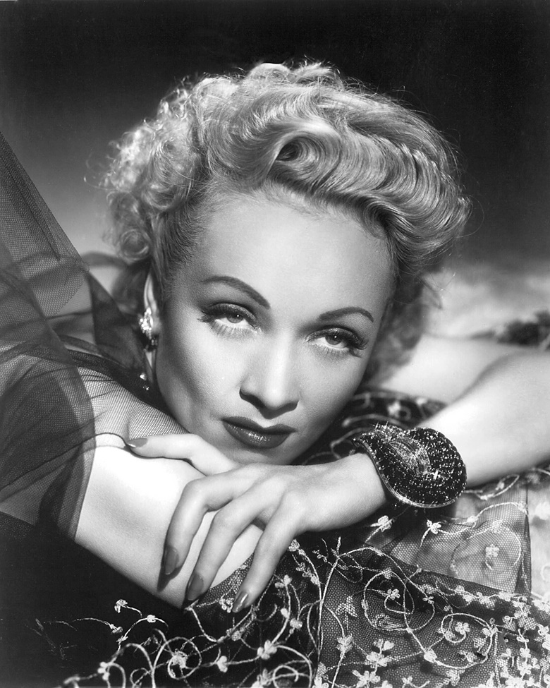 German-American actress Marlene Dietrich (1901-1992), c. 1940, wearing the Van Cleef & Arpels  ‘Jarretière’ bracelet. Photograph by Silver Screen CollectionGetty Images. TM & © 2023 M. Dietrich Inc. All Rights Reserved.