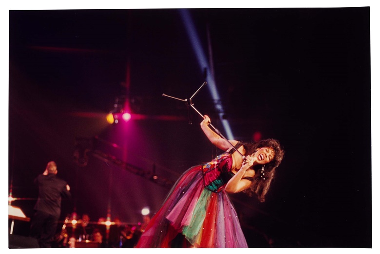 Photograph of Donna Summer on stage, 1990. 11⅞ x 18 in (30.1 x 45.5 cm). Estimate $200-300. Offered in The Collection of Donna Summer on 15-29 June 2023 at Christie’s online
