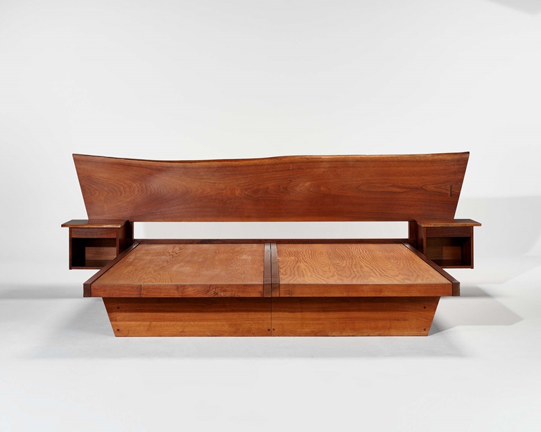 George Nakashima (1905-1990), King-size bed, 1973. American black walnut, rosewood, birch plywood. 38⅜ x 118¼ x 71 in (97.5 x 300.4 x 180.3 cm). Estimate $25,000-35,000. Offered in Art of Collecting A Pacific Island Connoisseur of Art and Design on 7 March 2023 at Christie’s New York