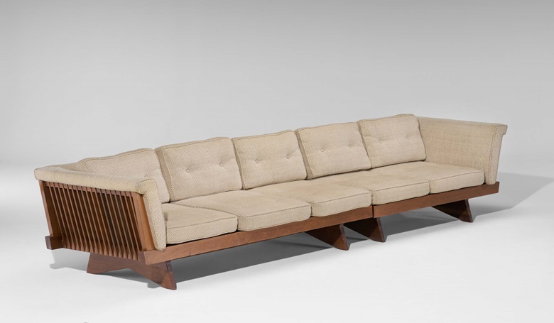 George Nakashima (1905-1990), Spindle sofa, Model No. 250, c. 1958. Walnut, fabric upholstery. 25¼ x 135 x 35 in (64.1 x 342.9 x 88.9 cm). Estimate $20,000-30,000. Offered in Art of Collecting A Pacific Island Connoisseur of Art and Design on 7 March 2023 at Christie’s New York