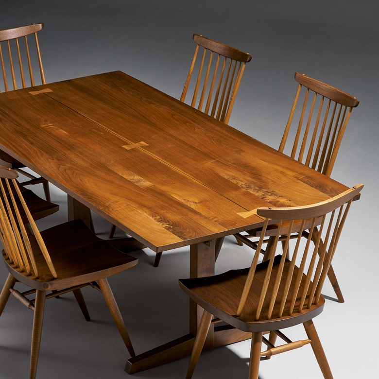 George Nakashima (1905-1990), Tresle dining table and set of six ‘’new’ chairs, 1982. American black walnut, mahogany table 28½ x 72 x 36¼ in (72.4 x 182.9 x 92 cm); chairs 35½ x 18½ x 19 in (90.2 x 47 x 48.3 cm). Estimate $20,000-30,000. Offered in Modern Collector Design, Tiffany Studios, and Property from a Pacific Island Connoisseur on 1-15 March