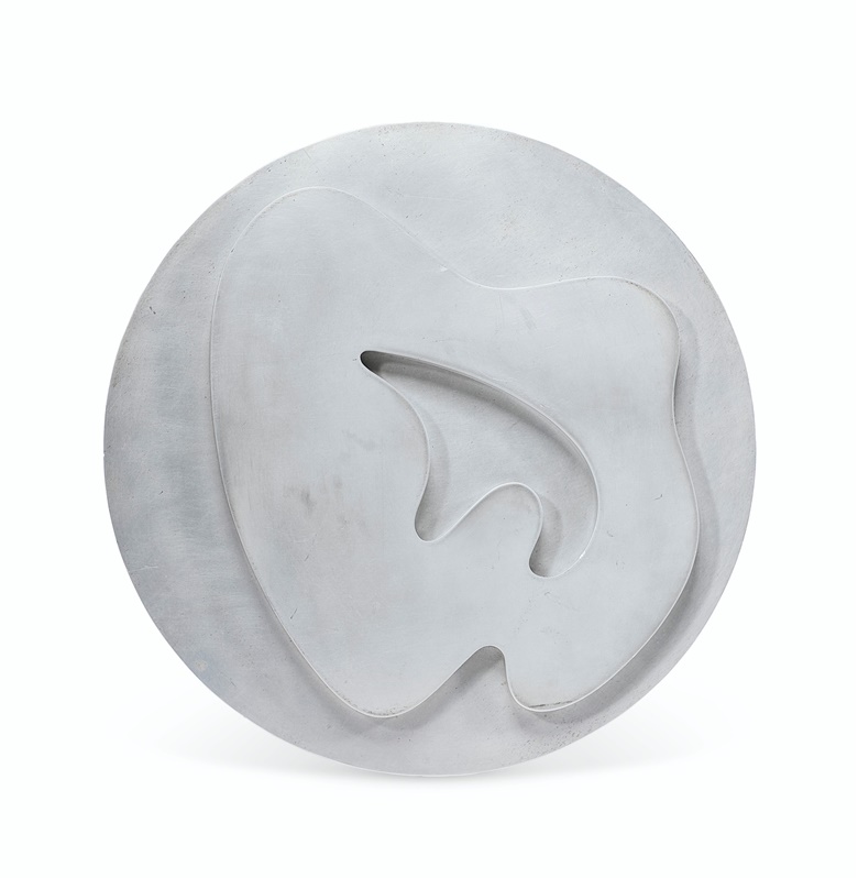 Jean (Hans) Arp (1895-1965), Composition dans un cercle no. 3, conceived and cast in 1962, signed and numbered ARP 15 (on the reverse). Duraluminium relief. Diameter 11⅞ in (30.1 cm). Estimate $10,000-15,000. Offered in Impressionist and Modern Art Day Sale on 14 May at Christie’s in New York