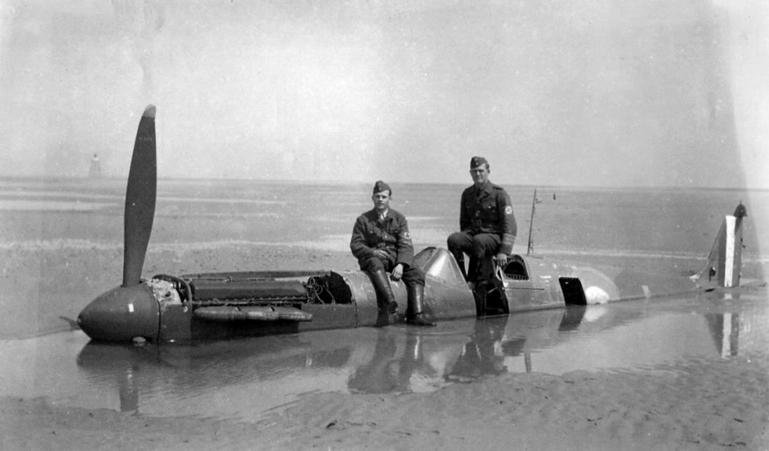 German soldiers posing with the wreckage of Spitfire P9374